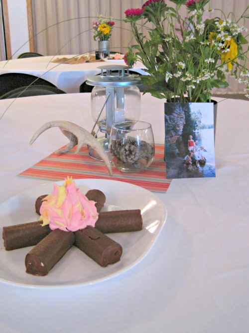 Camping themed rustic decor- lanterns, antlers, and wildflowers-- and don't forget the yummy "campfire!" | Retro Camper themed Party! table decorations wildflowers antlers lantern