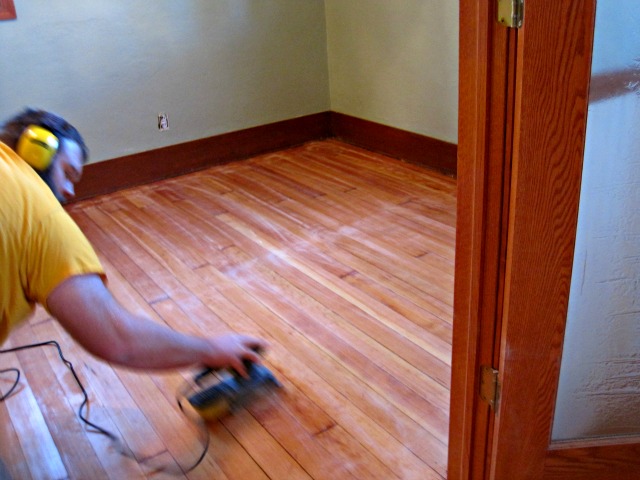 Sanding between coats of varnish helps to knock down any uneven edges and remove any dust specks | Refinishing hardwood floors sanding hardwood floor between coats of varnish