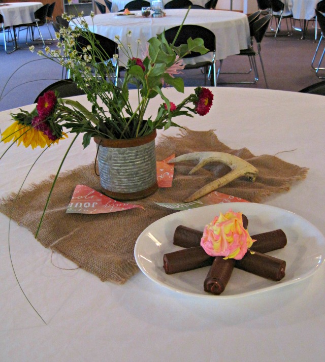 Camping themed rustic decor- lanterns, antlers, and wildflowers-- and don't forget the yummy "campfire!" | Retro Camper themed Party!