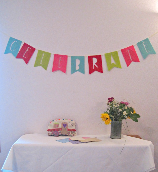 The Card Table-- time to celebrate! | A Retro Camper Themed Party cards on table wildflowers celebrate banner
